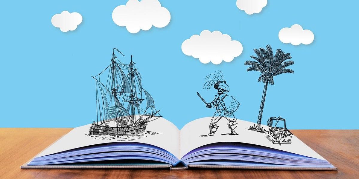 Livre ouvert sur table, ciel bleu, nuages, navire, pirate, palmier, coffre